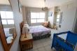 Main bedroom with double bed and baby cot & en-suite shower/toilets/wash basin