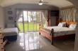 Large, bright Main Bedroom with sliding doors opening onto large garden area