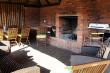 The outside area, includes braai/BBQ/fireplace. Gas BBQ and weber. Outdoor Dining table and outdoor 