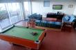 Entertainment room with pool table, TV and 3 sleeper couches