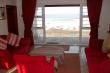 "Seaweed Cottage" lounge area view through French Doors to sea