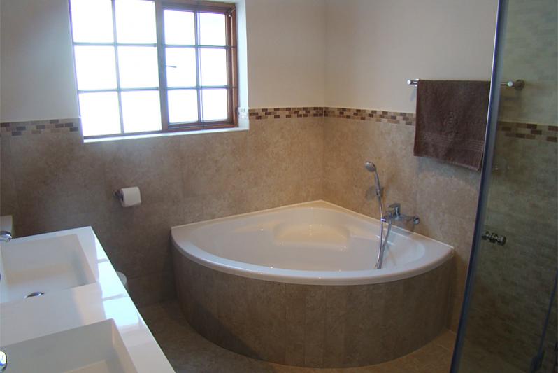 Bathroom groundfloor with bath, shower in bath, showercubicle,toilet and double washbasin