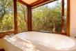 Thornwood Anthill Cottage bath with windows that open to the bush. 