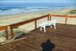 Walk about 70m onto the wooden deck on the secluded beach in front of the cottages