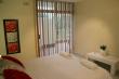 Bedroom 1 (Main) view to Balcony - Self Catering Apartment Accommodation in Umhlanga Rock
