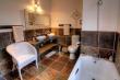 En-suite Bathroom with bath and double vanities in 2 of our Karoo View Cottages