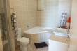 Bathroom en-suite with large corner bath and shower