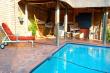 Swimming pool with sun deck & thatched barbeque area 