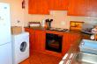 Unit 1 - Fully furnished kitchen with a washing machine 
