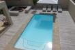 Solar heated pool with canterlever umbrella and fire pit beyond