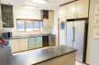 Kitchen with electric oven with gas hob, fridge-freezer and dishwasher.