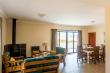 Open plan living / dining / kitchen area at Sunset Cottage with sliding doors on to private patio