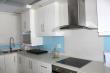 Modern kitchen with glas hob, stove & extractor canopy.