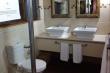 Upstairs bathroom with shower, double basin and toilet.,